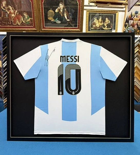 Classic custom football jersey framing with black fabric background in Singapore.
