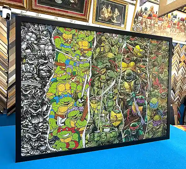 Completed jigsaw puzzle professionally direct framed in a black picture frame in Singapore.