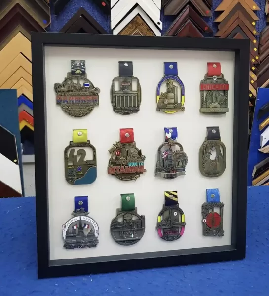 Custom medal framing displaying participation and achievement medals in Singapore.
