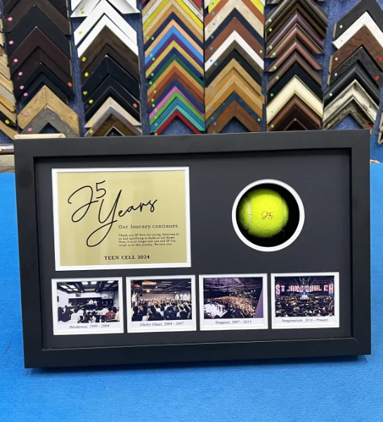 Custom tennis memorabilia shadow box with tennis ball, photographs, and commemorative items.
