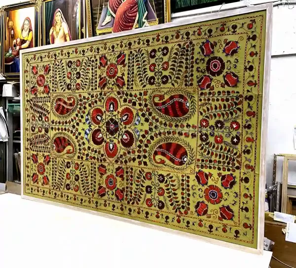 Traditional tapestry framing with a light wood frame for a large handcrafted textile artwork in Singapore.