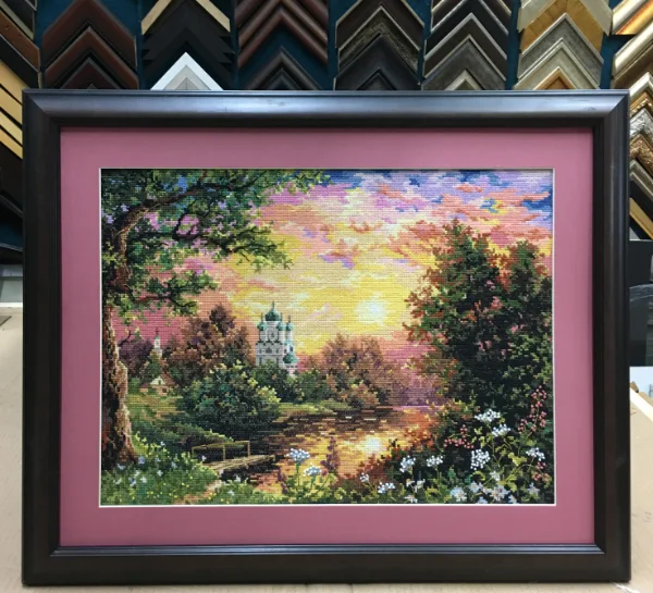 Handmade cross stitch artwork framed with a coloured mat board and wooden frame in Singapore.