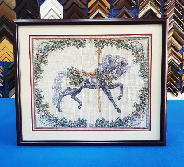 Custom cross stitch embroidery framed with a multi-layer mat board and wooden frame in Singapore.
